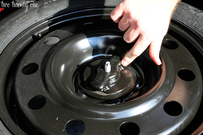 removing spare tire from car trunk