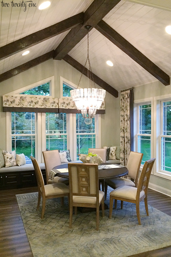 dining room with wooden ceiling beams and window seat