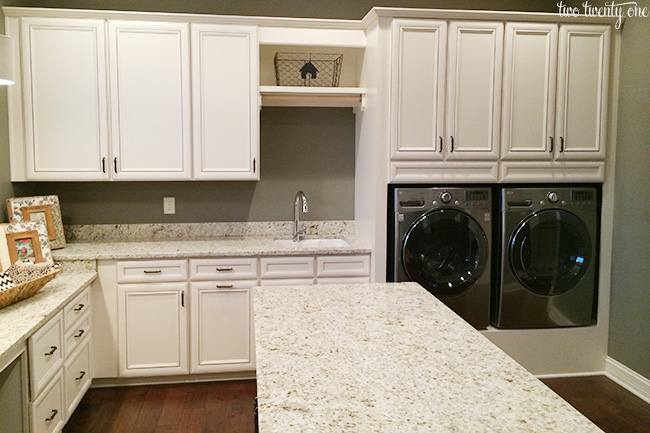 LOVE this large laundry room with sink and island to fold clothes