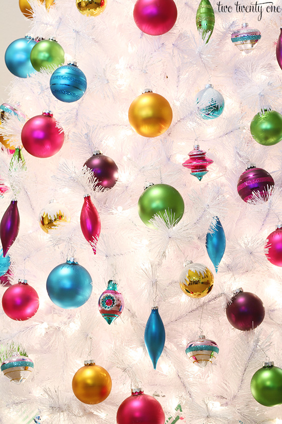 colorful ornaments on white christmas tree