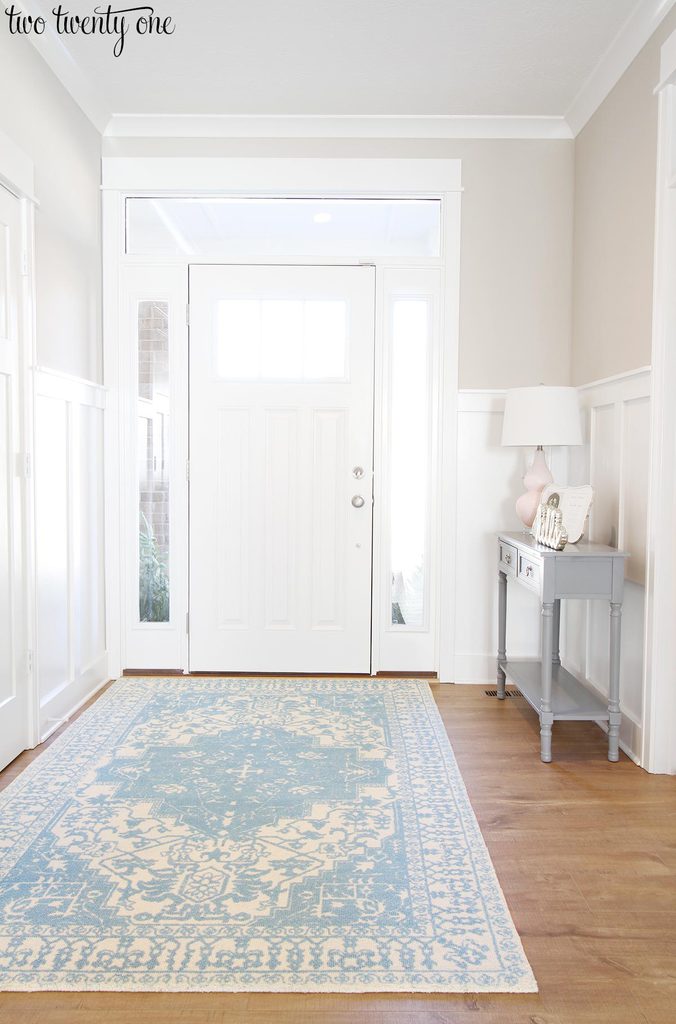 Entryway with SW Worldly Gray on the upper walls. SW Extra White on the door, board and batten, and trim.