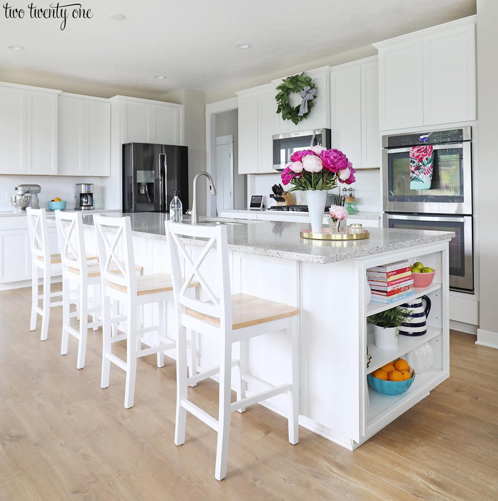 Kitchen with Sherwin Williams Worldly Gray walls and white shaker cabinets.