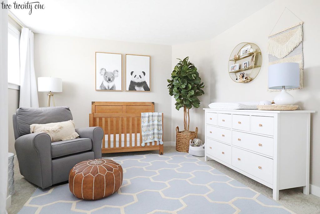 baby boy nursery with glider, crib, and dresser