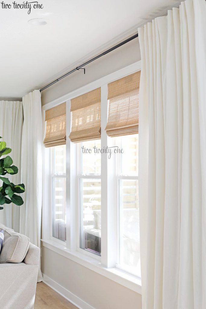 Woven shades with white curtains