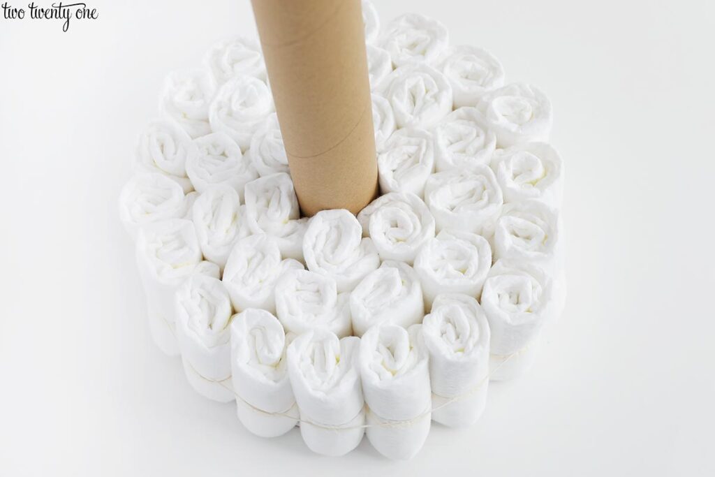 rolled up diapers circling a cardboard roll