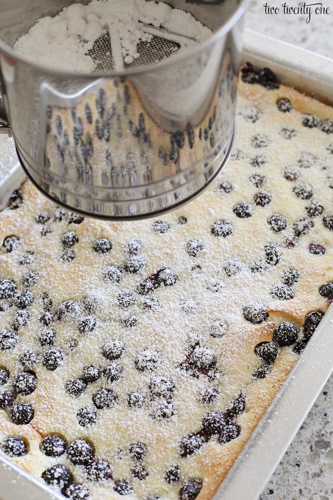 dusting cake with powdered sugar