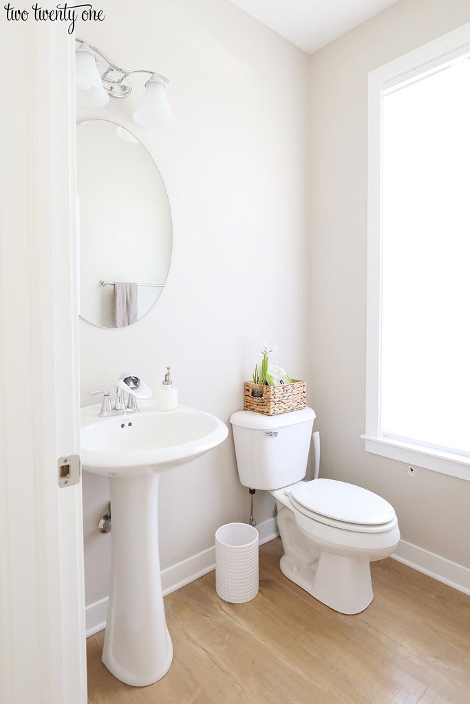powder room with pedestal sink, mirror, light, toilet, and window