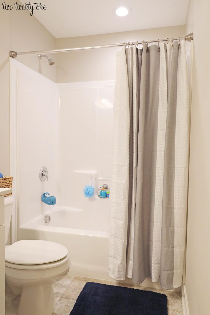 shower with gray and white shower curtain