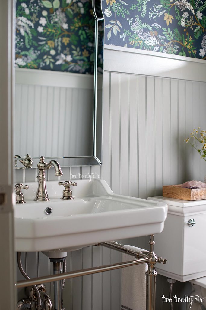 victoriahaus console sink with kingston brass faucet in a powder room