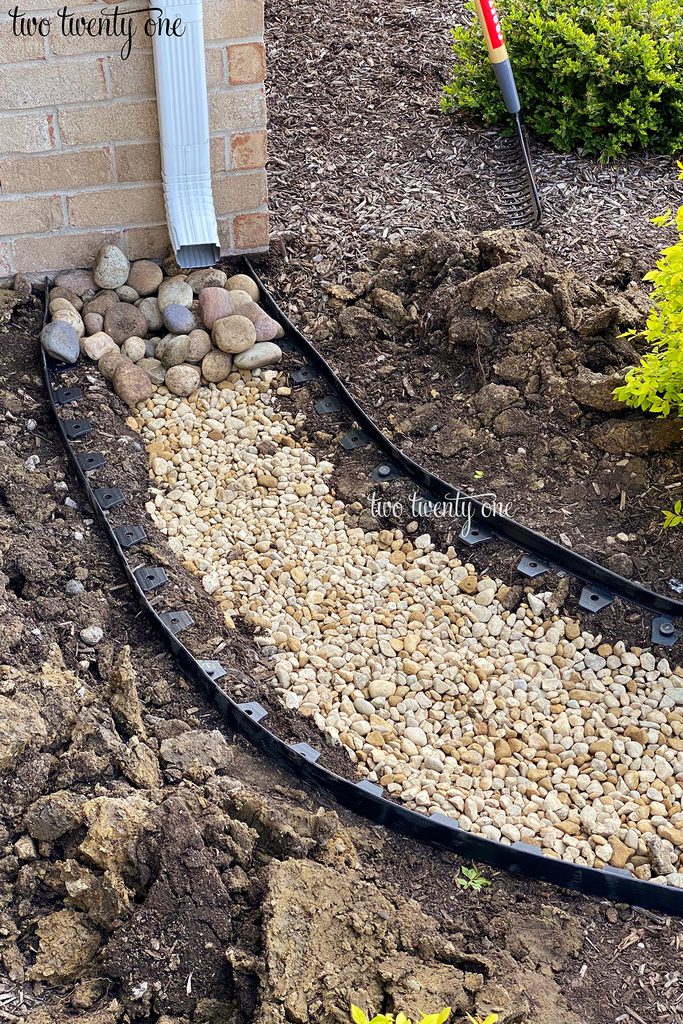 adding large river rocks to dry creek bed