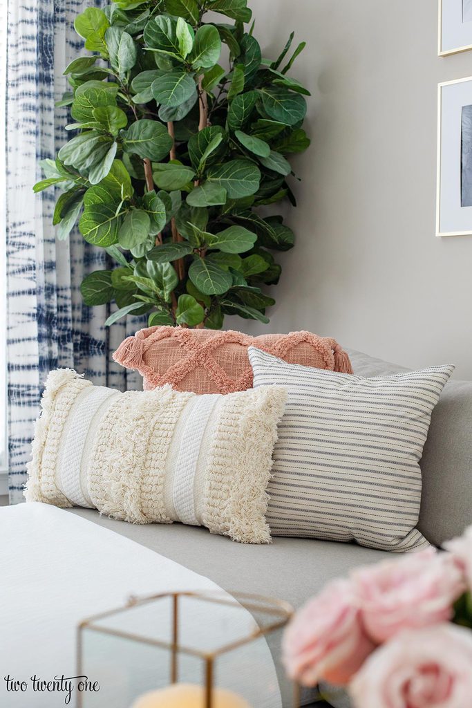 three pillows on a gray couch