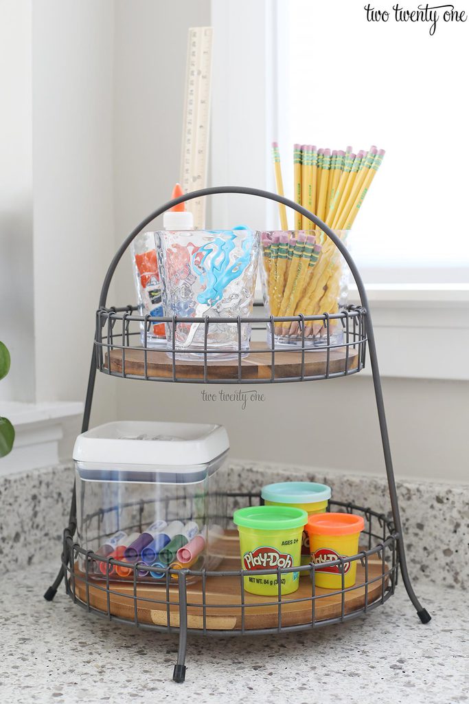 tiered tray with school supplies on it