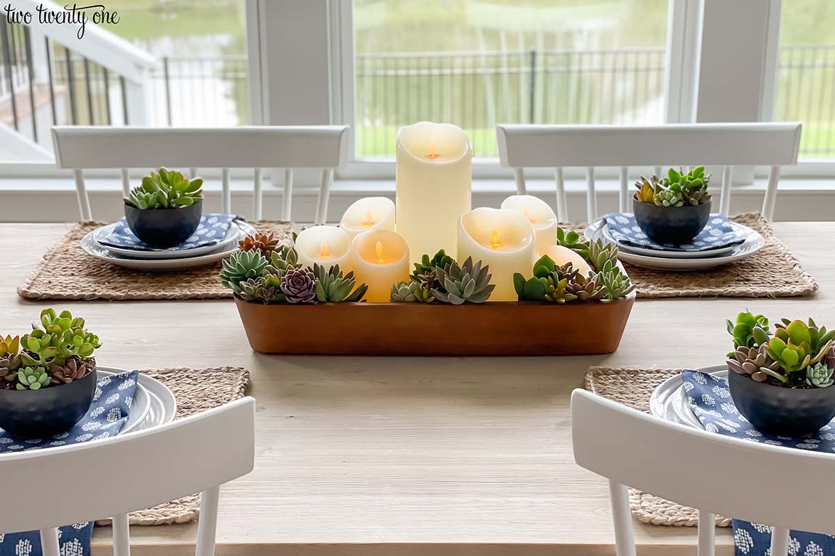 Table setting with a succulent and candles centerpiece