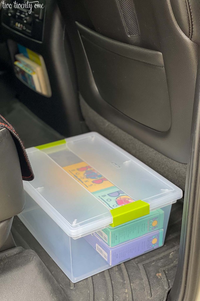 Four sets of BOB Books inside a plastic container in a car.
