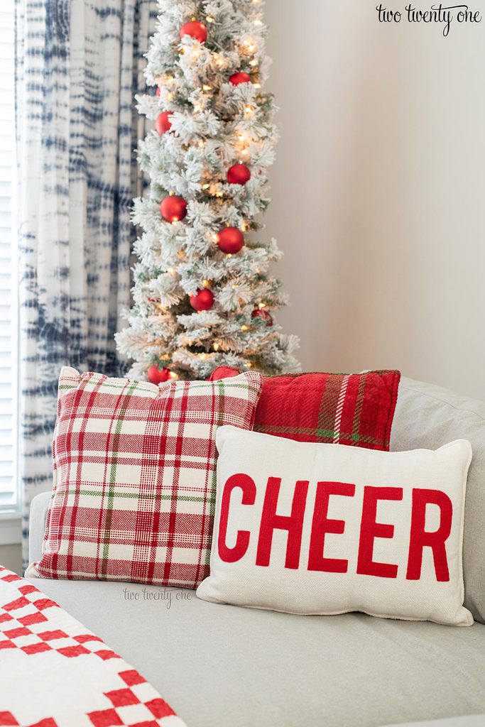 white pillow with the word cheer on it in red