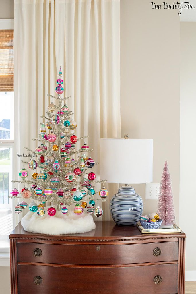 Tabletop silver tinsel Christmas tree with colorful glass ornaments