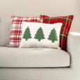 plaid holiday pillows and a pillow with green trees on it