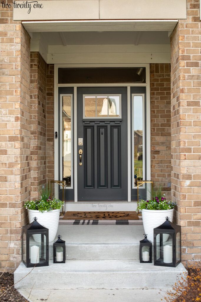 front porch stairs with black lanterns and white planters