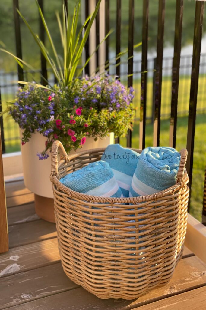 three blue and white striped towels in a woven basket