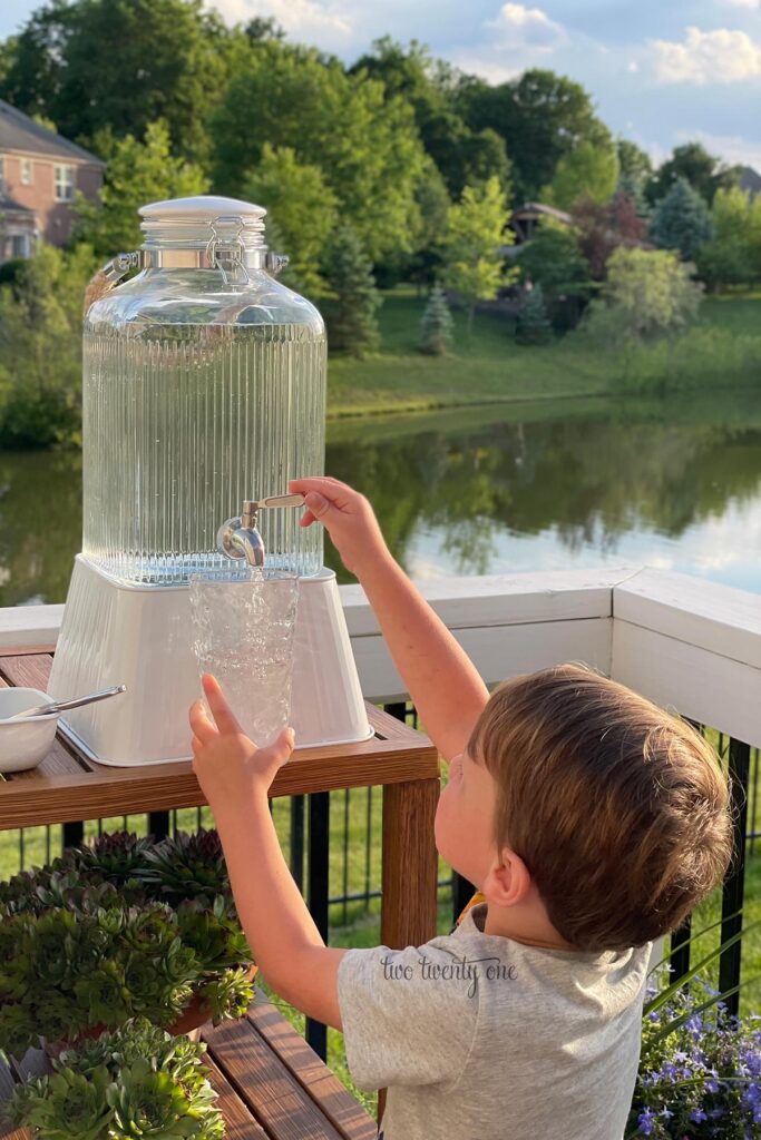 boy getting water out of a drink dispenser