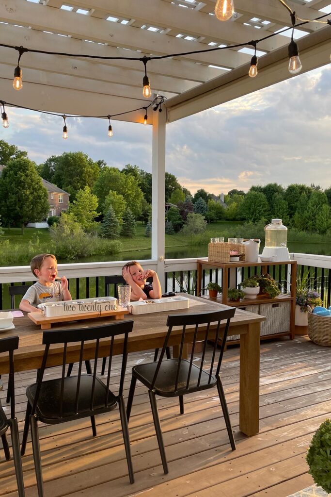 deck with a dining table and black chairs