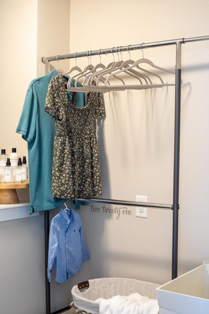 garment rack with three shirts hanging on it