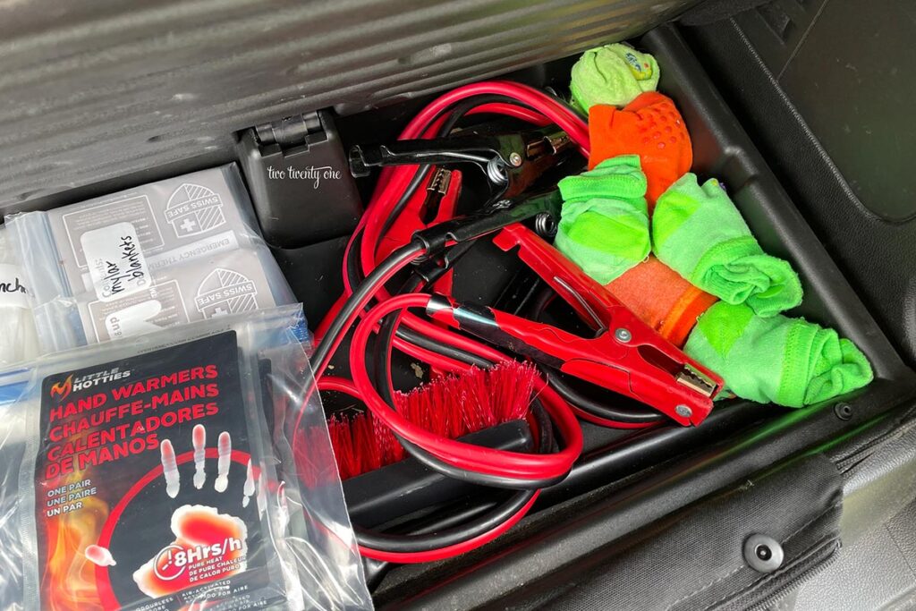 hidden trunk compartment with hand warmers, mylar blankets, jumper cables, socks