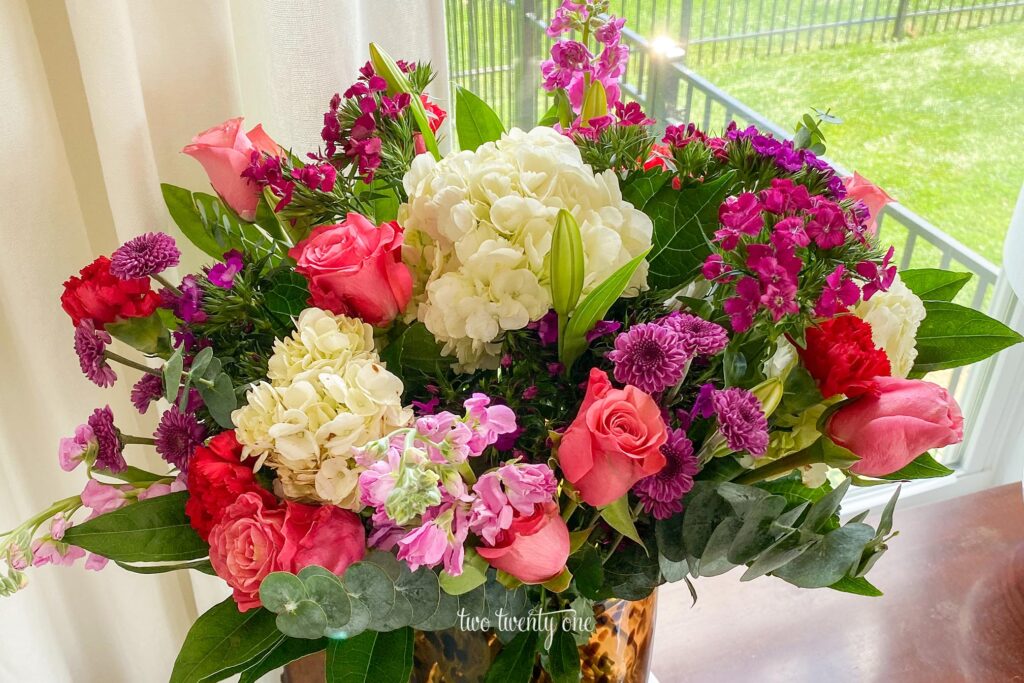 A bouquet of white, purple, and pink flowers.