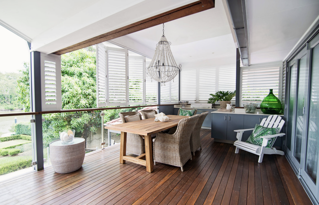 White louvered aluminum shutters used as privacy screen on deck